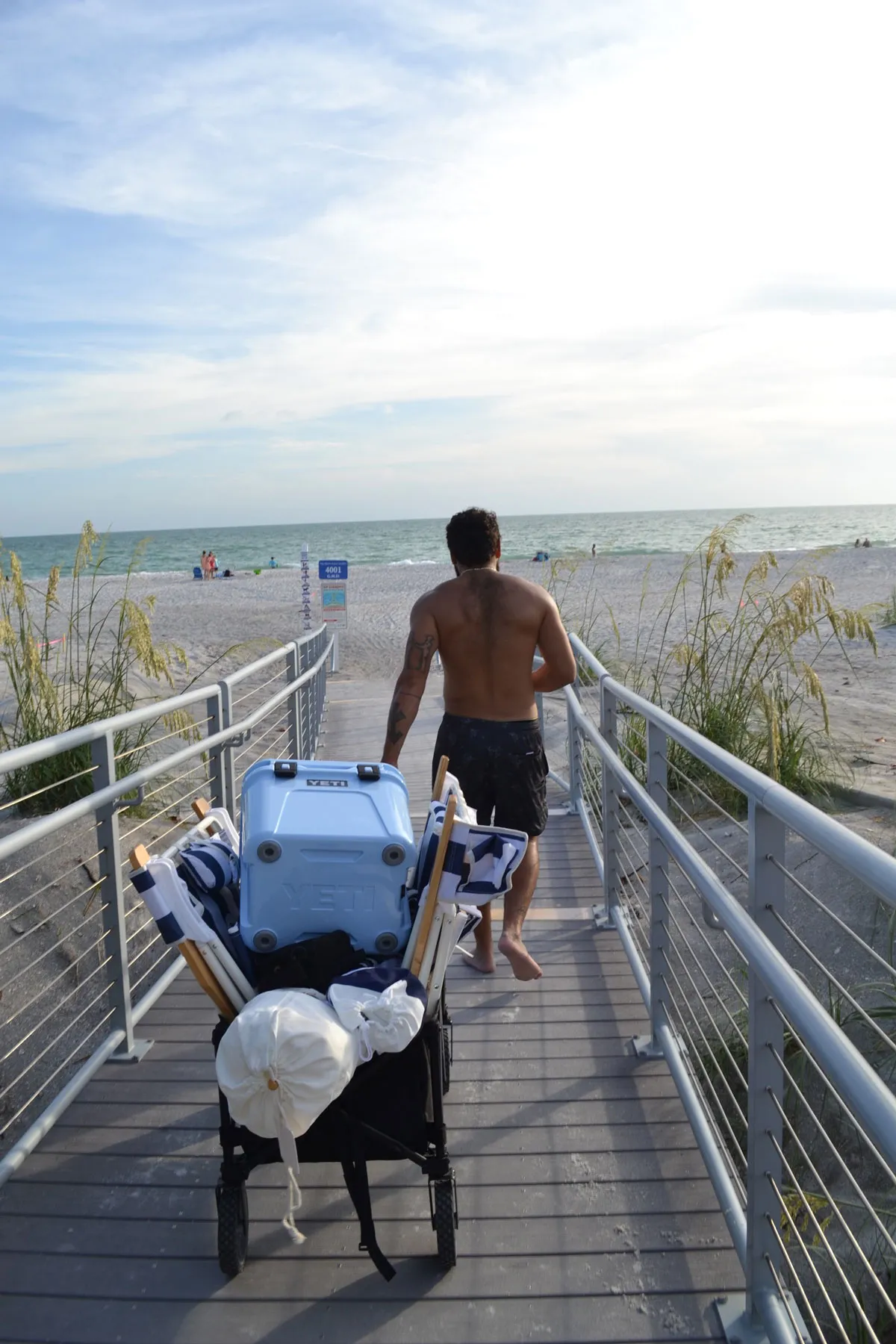 Family carting cabana gear to the beach